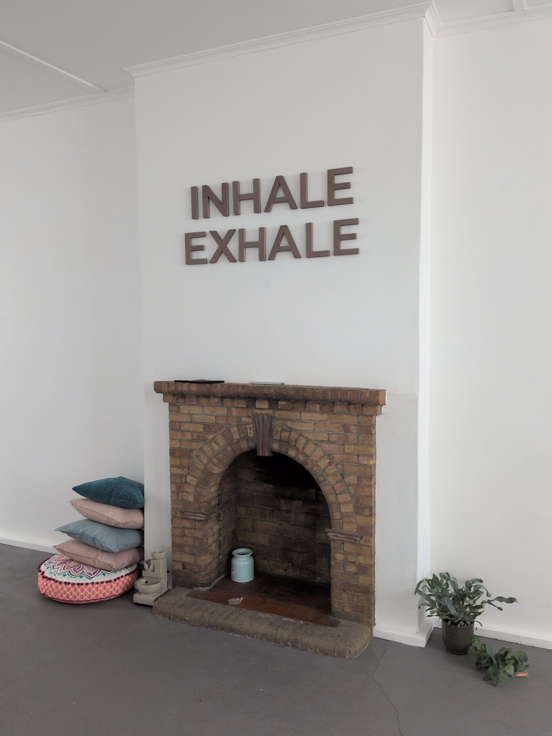 Fireplace and Inhale Exhale wall inside the Studio
